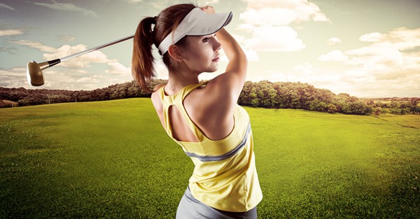 Woman golf player swinging with golf club